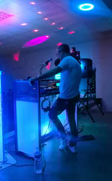 a man playing a keyboard in a room with a microphone and a keyboard