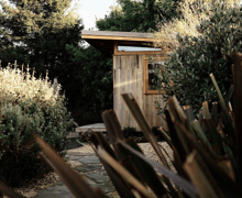 Prefab modular tiny home with outdoor garden pathway