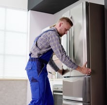 a man installing the refrigerator