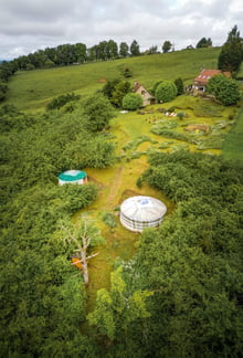 a farm with a round shaped structure and a round shaped structure