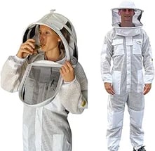 a man in a bee suit with a beekeeper