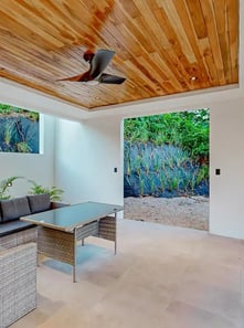 a living room with a ceiling fan and a ceiling fan