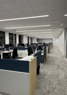 A large room filled with office cubicles.