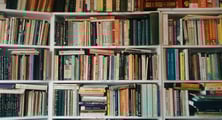 a book shelf full of medical and alternative books and bookshelves