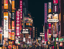 a busy street with many signs in a Tokyo Night