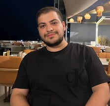 a man sitting at a table with a plate of food