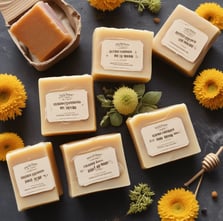 A large honeycomb displayed on a stand with the word 'honey' on a small chalkboard sign. Surrounding the honeycomb are various jars, possibly containing honey or spreads, and a collection of arranged small jars in the background.