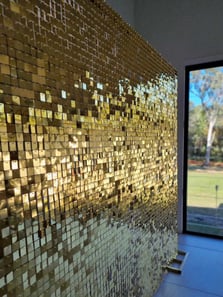 Gold shimmer wall glimmering for Maria's 60th birthday in Alexandra Hills, with the light dancing on its sequins.