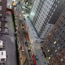 a city street scene with a train on the tracks