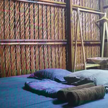 Simple yet airy room facing an open courtyard with rustic wood and nature all around.