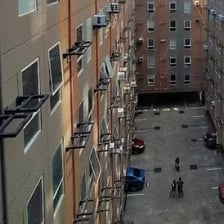 a group of people walking around a courtyard
