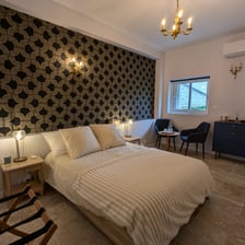 a bedroom with a bed and a chair