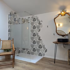 a bathroom with a chair and a mirror