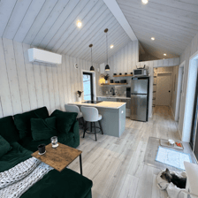 Cozy interior of tiny home pod with kitchen and seating