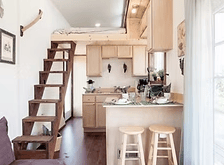 Cozy kitchen and loft space inside tiny home pod