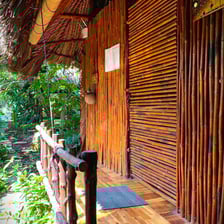 Spacious twin-bed room with large windows overlooking the tropical vegetable garden.