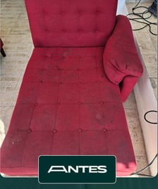 a red couch with a red couch and a black chair