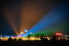 Party at the beach with color lights and people dancing