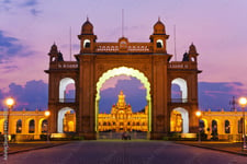 A palace entrance illuminated with lights during the night time