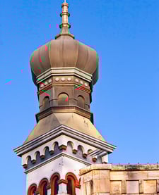 Historic Georgetown, Texas building featuring iconic onion dome architecture under a bright blue sky.