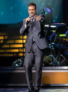 Scott Keo pointing to hi audience, at his World Renown Michael Buble' Tribute Artist Singer Show