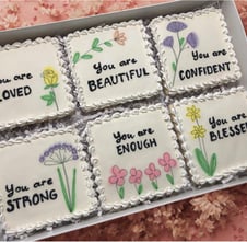 Gift box with beautifully decorated cookies with royal icing and uplifting messages like You are beautiful, strong, blessed