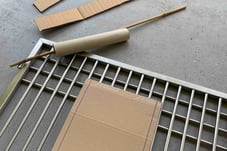 image showing cage door frame with cardboard paper in development