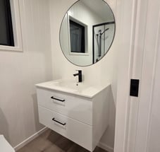 Bathroom vanity with large round mirror