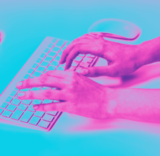 a person's hands typing on a keyboard