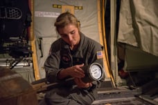 U.S. Naval Academy Midshipman First Class Julia Von Fecht aboard a WC-130J Super Hercules readies an AXBT. USAF photo