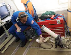 NOAA operator releases a dropsonde aboard a WP-3D Orion reconnaissance Hurricane Hunter aircraft from the inside.
