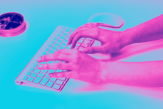 a person's hands typing on a keyboard
