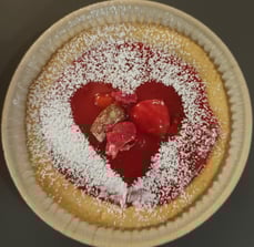 a pie crust pie with a heart shaped piece of cake