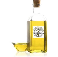 a bottle of olive oil with a bowl of olive oil