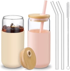 a glass jar with a straw and a strawberries in it