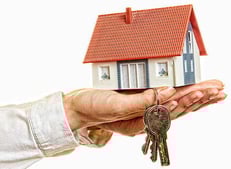 a person holding a keychaik in their hand