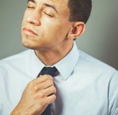 a man in a blue shirt and tie tie