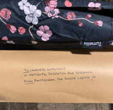 note from Tumella Flip-proof Travel Umbrella creators to customer and cherry blossom umbrella design