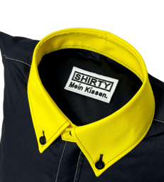 a black shirted pillow with a yellow collar and label