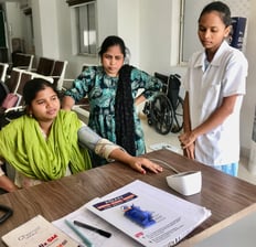 nurse checking patient BP