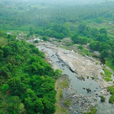 a river with rocks and rocks in the foreground