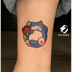 Photo of a color cartoon tattoo above the ankle