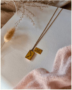 a necklace a small gold envelope. It is written necklace.
