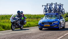 Tour of Britain Wrexham stage two, Commissaire bike overtaking Shimano tour car.