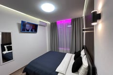 a bedroom with a television and a television