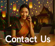 Smiling Thai woman in traditional dress assisting customers by phone at GoThaiBooking contact center