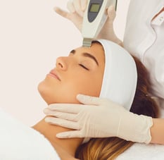 a woman getting a facial lift in a beauty salon