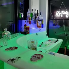 Glow corner bar setup with let's party neon in the backdround at hire event in Redlands.