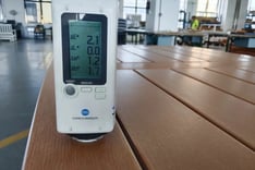 Konica Minolta colorimeter measuring color consistency on an HDPE outdoor furniture surface