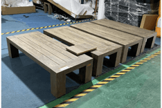 Quality control comparison of finished patio tables with a sample panel, demonstrating color